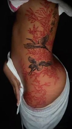 a woman's back with birds and flowers on it