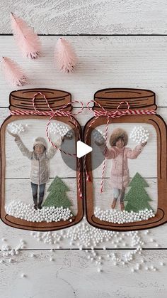 two mason jars are decorated with christmas trees