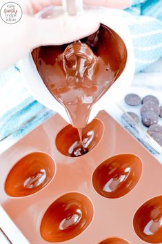 someone pouring chocolate into a muffin pan