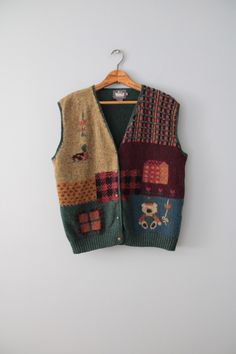 vintage rare essential cabin/cottage core aesthetic dark autumn color warmest wool intarsia knitwork vest. featuring cutest bear, duck and farm house in moody autumn front and pine green back. embossed flower buttons in antiqued brass.  100% wool   Made by Woolrich  Fits best like oversize or large (tag vintage size L): 16" shoulders 44" bust 22" length Condition: excellent! ✮ shop our selection of vintage knitwear here: https://etsy.me/3XGKMBb ✮ shop The Veiled Ghost handmade jewelry: https://etsy.me/32CDNCC ✮ shop Adrian Company Vintage: https://etsy.me/3u2Ewbi Vintage Green Vest For Fall, Green Vintage Vest For Fall, Knitwear Aesthetic, Moody Autumn, Etiquette Vintage, Cabin Cottage, Vintage Knitwear, Artsy Outfit, Dark Autumn