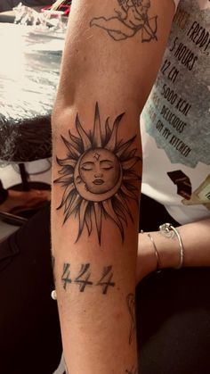 a person with a sun tattoo on their arm