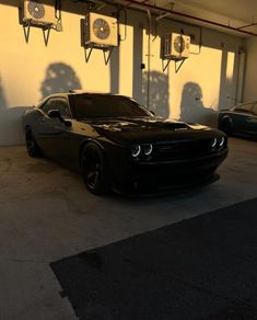 a black car is parked in a garage