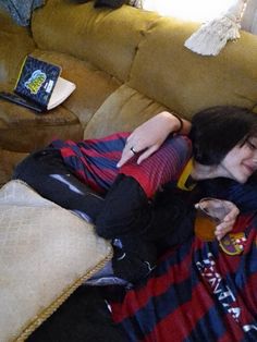 two people laying on a couch hugging each other