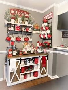 a christmas display in the corner of a room with red and white decorations on it