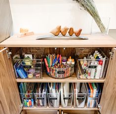 an open cabinet filled with lots of crafting supplies