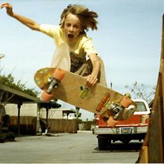 a young person jumping in the air with a skateboard