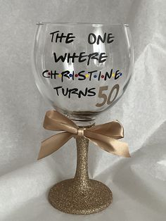 a wine glass with the words, the one where christing turns 50