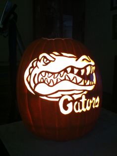 a carved pumpkin with the word gator on it