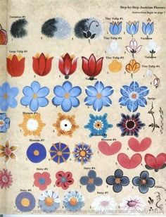 an open book with many different types of flowers on the pages, including blue and red