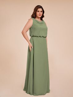 a woman in a green dress posing for the camera with her hands on her hips