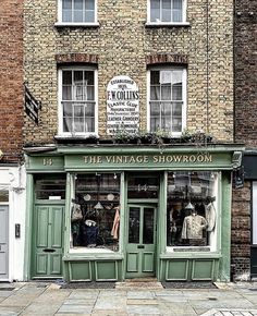 the vintage showroom is located in an old brick building with green doors and windows