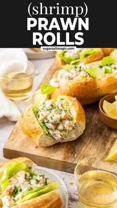 shrimp prawn rolls on a cutting board with lemon wedges