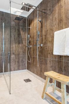 a bathroom with a shower and wooden bench in front of it, the title says 9 mistakes with a barrier free shower system you don't want to make