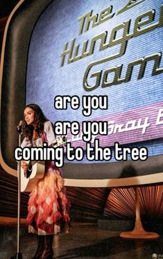 a woman standing in front of a tv with the words are you coming to the tree?