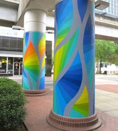 two colorfully painted columns in front of a building