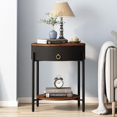 a small table with a clock on it next to a couch