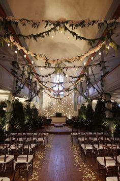 the interior of a church decorated with flowers and greenery