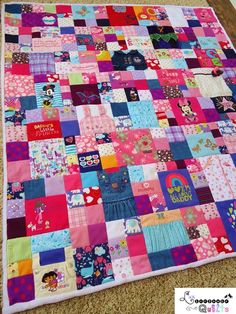 a colorful patchwork quilt is laying on the floor