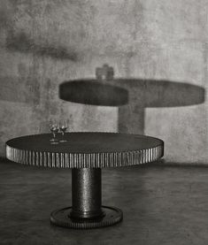 a black and white photo of a table with two pedestals in the back ground