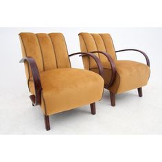 a pair of mid century modern chairs with curved back and armrests in the style of art deco