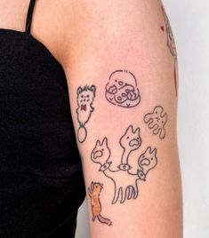 a woman's arm with tattoos on it that include cats, dogs and other things