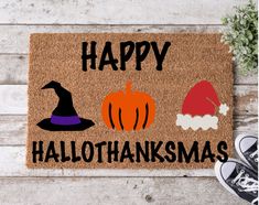 a door mat with the words happy halloween on it and two pumpkins in hats