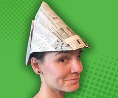 a woman with a newspaper hat on her head