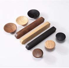 an assortment of wooden and black objects on a white surface