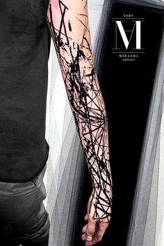 a man's arm is covered in black ink and has an abstract design on it