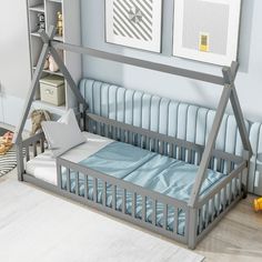 a baby's room with a bed, bookshelf and pictures on the wall