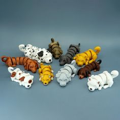 there are many different toy animals together on the table and one is black, white, brown, and orange