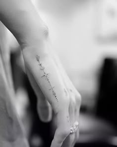 a woman's hand with a small tattoo on the wrist that says, i love you