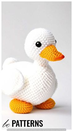 a crocheted white duck sitting on top of a table