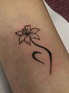 a woman's arm with a flower tattoo on it