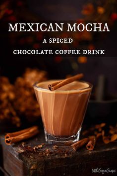 mexican mocha is served in a glass with cinnamons and spices around the rim