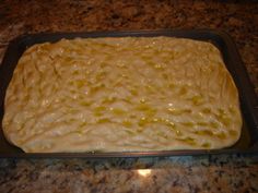 a pan filled with batter sitting on top of a counter