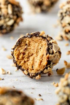 chocolate chip cookie doughnuts with nuts on top and one cut in half to show the inside