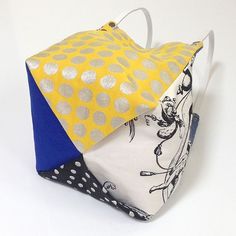 an origami style bag with polka dots on it