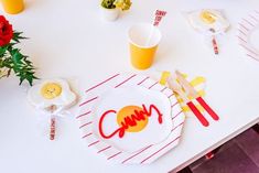 a white table topped with plates covered in eggs and other food on top of it