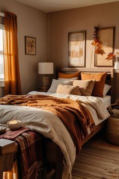 a bedroom with a large bed covered in blankets and pillows