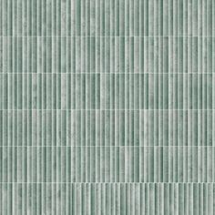 a green tile wall with vertical lines on it