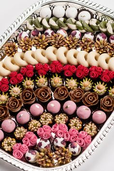 a platter filled with lots of different types of desserts on top of each other