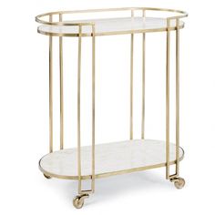 a gold metal and glass bar cart