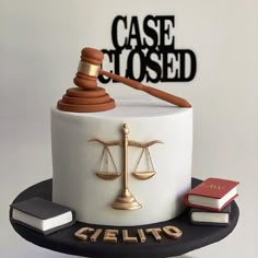 a cake with a judge's scale and book on top