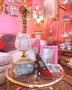 a living room filled with furniture and pink walls