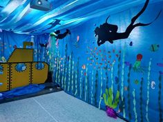 an underwater themed bedroom with blue walls and under water decorations on the walls, along with yellow submarine bedding