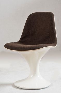 an egg chair with a brown seat and white base