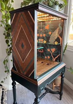 an old - fashioned game machine is painted with flowers and birds on it's sides