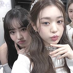 three young women are posing for the camera with their hands on their hipss and one is wearing a tiara