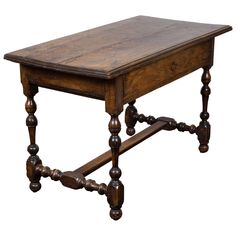 an old wooden table with turned legs